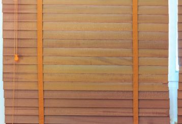 Natural faux wood blinds providing privacy and style in a cozy bedroom