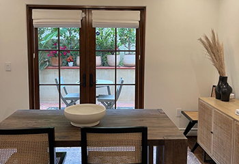 Luxury dining space adorned with white Roman shades