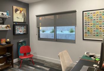 Stylish teen bedroom in San Diego featuring half-lowered sheer window shades, balancing privacy and soft sunshine.