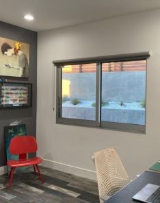 Contemporary San Diego teen bedroom with custom sheer window shades fully open, inviting natural daylight.